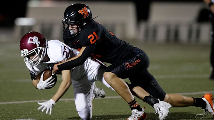West De Pere's Cooper Borowicz (21) makes a tackle versus De Pere during a Fox River Classic Conference (North Division) game on Sept. 27, 2024
