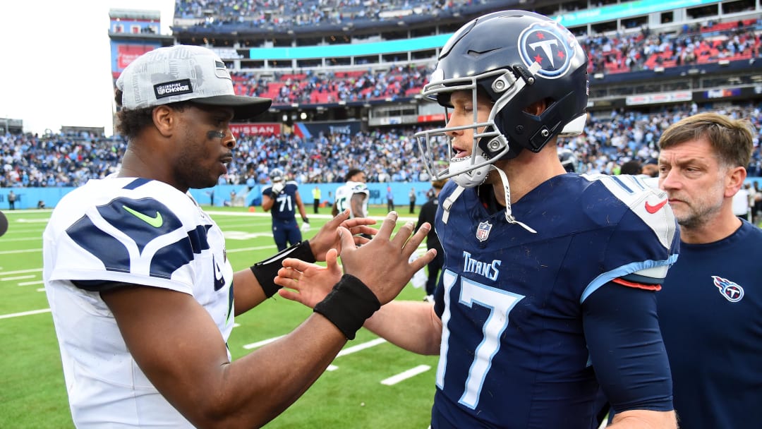Dec 24, 2023; Nashville, Tennessee, USA; Seattle Seahawks quarterback Geno Smith (7) and Tennessee Titans quarterback Ryan Tannehill (17) after a Seahawks win at Nissan Stadium. Mandatory Credit: Christopher Hanewinckel-USA TODAY Sports