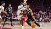Dec 1, 2021; Fayetteville, Arkansas, USA;  Central Arkansas Bears guard Camren Hunter (23) drives around Arkansas Razorbacks guard Davonte Davis (4) during the first half at Bud Walton Arena. Mandatory Credit: Brett Rojo-Imagn Images
