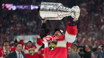 Jun 17, 2025; Sunrise, Florida, USA; Florida Panthers goaltender Sergei Bobrovsky (72) hoists the Stanley Cup after winning game six of the 2025 Stanley Cup Final against the Edmonton Oilers at Amerant Bank Arena. Mandatory Credit: Jim Rassol-Imagn Images