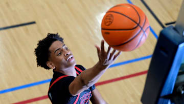 July 18, 2024; North Augusta, S.C., USA; A photographer's flash goes off as Kiyan Anthony, son of NBA star Carmelo Anthony, warms up before the Team Melo and Georgia Stars game at the Nike Peach Jam at Riverview Park Activities Center. The Georgia Stars won 64-63.