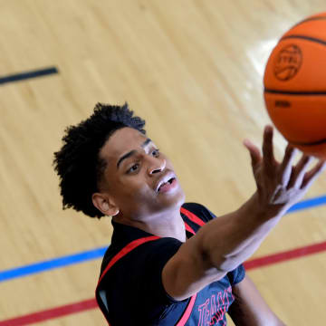 July 18, 2024; North Augusta, S.C., USA; A photographer's flash goes off as Kiyan Anthony, son of NBA star Carmelo Anthony, warms up before the Team Melo and Georgia Stars game at the Nike Peach Jam at Riverview Park Activities Center. The Georgia Stars won 64-63. Mandatory Credit: Katie Goodale-USA TODAY Network