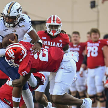 Indiana Hoosiers defensive lineman Venson Sneed Jr. (55) and Indiana Hoosiers linebacker Rolijah Hardy (21) tackle Florida International Panthers quarterback Amari Jones (2) during the second half at Memorial Stadium.