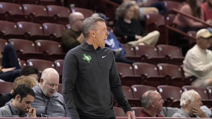 Nov 19, 2023; Charleston, SC, USA; Current WVU and former North Texas head coach Ross Hodge reacts to a call on the court in the first half against the Towson Tigers at TD Arena. Mandatory Credit: David Yeazell-Imagn Images