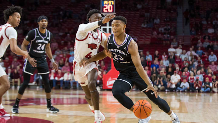 Dec 1, 2021; Fayetteville, Arkansas, USA;  Central Arkansas Bears guard Camren Hunter (23) drives around Arkansas Razorbacks guard Davonte Davis (4) during the first half at Bud Walton Arena. Mandatory Credit: Brett Rojo-Imagn Images