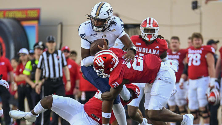 Indiana Hoosiers defensive lineman Venson Sneed Jr. (55) and Indiana Hoosiers linebacker Rolijah Hardy (21) tackle Florida International Panthers quarterback Amari Jones (2) during the second half at Memorial Stadium.