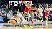 Mar 5, 2025; South Bend, Indiana, USA; Notre Dame Fighting Irish guard Markus Burton (3) and Stanford Cardinal guard Jaylen Blakes (21) reach for a loose ball in the second half at the Purcell Pavilion. Mandatory Credit: Matt Cashore-Imagn Images