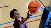 July 18, 2024; North Augusta, S.C., USA; A photographer's flash goes off as Kiyan Anthony, son of NBA star Carmelo Anthony, warms up before the Team Melo and Georgia Stars game at the Nike Peach Jam at Riverview Park Activities Center. The Georgia Stars won 64-63. Mandatory Credit: Katie Goodale-USA TODAY Network