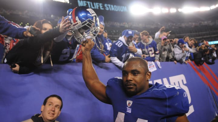 In this Jan. 1, 2012 photos, New York Giants running back Ahmad Bradshaw (44) gets high fives from fans after defeating the Dallas Cowboys at MetLife Stadium.

2423f561 00001