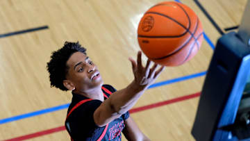 July 18, 2024; North Augusta, S.C., USA; A photographer's flash goes off as Kiyan Anthony, son of NBA star Carmelo Anthony, warms up before the Team Melo and Georgia Stars game at the Nike Peach Jam at Riverview Park Activities Center. The Georgia Stars won 64-63. Mandatory Credit: Katie Goodale-USA TODAY Network