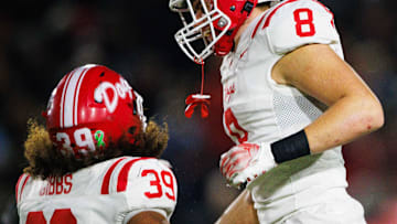 Crown Point's Trevor Gibbs (39) and Jacob Soley (8) celebrate getting a stop during the IHSAA Class 6A Sectional final between No. 2 Crown Point and Penn at Penn High School on Friday, Nov. 8, 2024, in Mishawaka.
