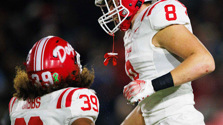 Crown Point's Trevor Gibbs (39) and Jacob Soley (8) celebrate getting a stop during the IHSAA Class 6A Sectional final between No. 2 Crown Point and Penn at Penn High School on Friday, Nov. 8, 2024, in Mishawaka.