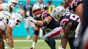 Sep 14, 2025; Miami Gardens, Florida, USA; New England Patriots center Garrett Bradbury (65) lines up against the Miami Dolphins in the fourth quarter at Hard Rock Stadium. Mandatory Credit: Nathan Ray Seebeck-Imagn Images