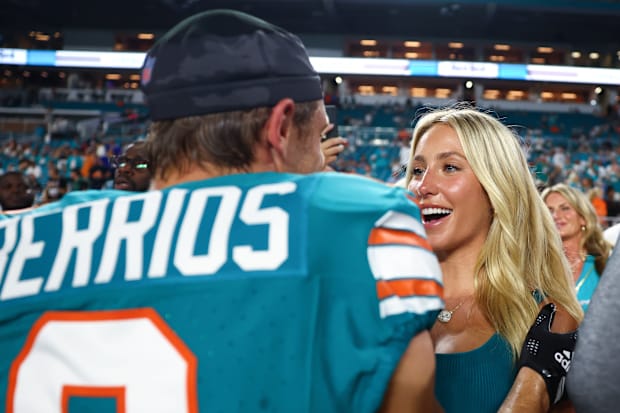 Braxton Berrios #0 of the Miami Dolphins and Alix Earle talk prior to a game against the Buffalo Bills at Hard Rock Stadium o