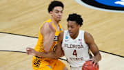 Mar 20, 2021; Indianapolis, Indiana, USA; Florida State Seminoles guard Scottie Barnes (4) dribbles the ball while defended by UNCG Spartans forward Angelo Allegri (L) during the second half in the first round of the 2021 NCAA Tournament at Bankers Life Fieldhouse. Mandatory Credit: Kirby Lee-Imagn Images