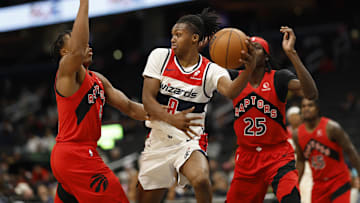 Oct 11, 2024; Washington, District of Columbia, USA; Washington Wizards guard Bub Carrington (8) leaps to pass the ball Toronto Raptors forward Scottie Barnes (4) defends in the second quarter at Capital One Arena. Mandatory Credit: Geoff Burke-Imagn Images