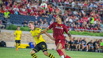 Jul 19, 2019; South Bend, IN, USA; Liverpool defender Virgil van Dijk (4) and Borussia Dortmund forward Jacob Bruun Larsen (34) fight for the ball in the second half of a preseason preparation soccer match at Notre Dame. Mandatory Credit: Trevor Ruszkowski-Imagn Images