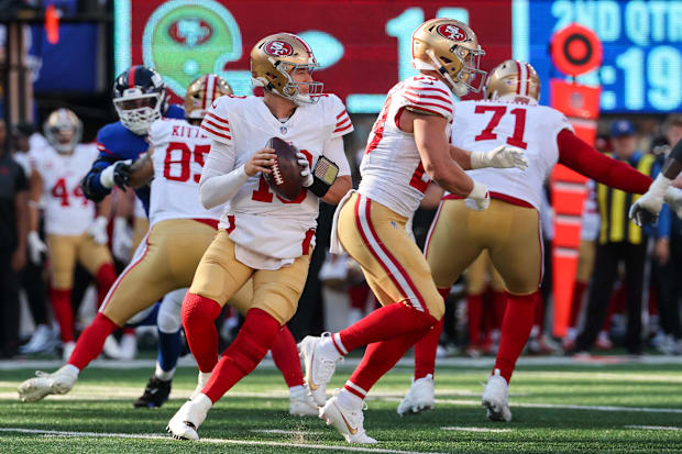 Mac Jones holds the ball in the pocket.
