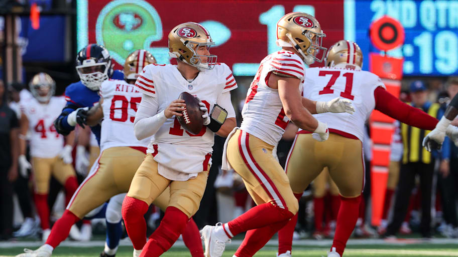 Mac Jones holds the ball in the pocket.