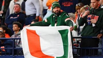 Nov 30, 2024; Syracuse, New York, USA; A Miami Hurricanes fan holds a flag during the first half against the Syracuse Orange at the JMA Wireless Dome. Mandatory Credit: Rich Barnes-Imagn Images