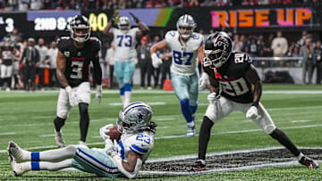 Nov 3, 2024; Atlanta, Georgia, USA; Dallas Cowboys running back Rico Dowdle (23) makes a juggling catch for a touchdown against Atlanta Falcons cornerback Dee Alford (20) during the first half at Mercedes-Benz Stadium. Mandatory Credit: Dale Zanine-Imagn Images