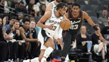 Apr 14, 2024; San Antonio, Texas, USA; San Antonio Spurs guard Tre Jones (33) looks to pass the ball while defended by Detroit Pistons 23 guard Jaden Ivey (23) during the first half at Frost Bank Center. Mandatory Credit: Scott Wachter-USA TODAY Sports