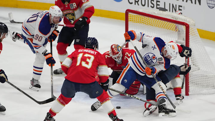 Jun 9, 2025; Sunrise, Florida, USA; Florida Panthers goaltender Sergei Bobrovsky (72) and forward Sam Reinhart (13) defend against Edmonton Oilers center Ryan Nugent-Hopkins (93) and right wing Corey Perry (90) during the first period in game three of the 2025 Stanley Cup Final at Amerant Bank Arena. 