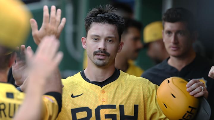 Jul 18, 2025; Pittsburgh, Pennsylvania, USA;  Pittsburgh Pirates right fielder Bryan Reynolds (10) high-fives in the dugout after scoring a run against the Chicago White Sox during the fourth inning at PNC Park. Mandatory Credit: Charles LeClaire-Imagn Images