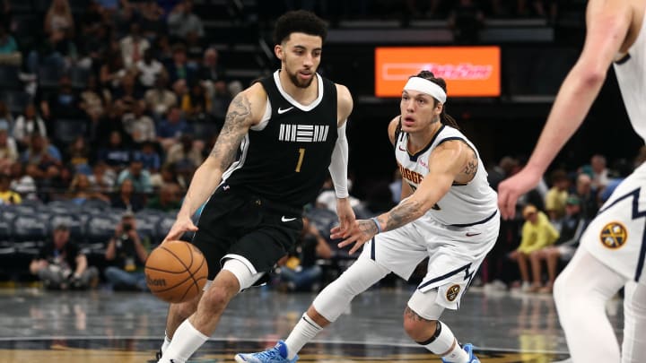 Apr 14, 2024; Memphis, Tennessee, USA; Memphis Grizzlies guard Scotty Pippen Jr. (1) dribbles as Denver Nuggets forward Aaron Gordon (50) defends during the second half at FedExForum. Mandatory Credit: Petre Thomas-USA TODAY Sports