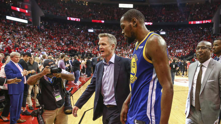 May 6, 2019; Houston, TX, USA; Golden State Warriors head coach Steve Kerr (center) and forward Kevin Durant (35) walk off the court after game four of the second round of the 2019 NBA Playoffs against the Houston Rockets at Toyota Center. 