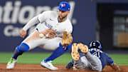 Toronto Blue Jays shortstop Bo Bichette (11) tags out Tampa Bay Rays left fielder Chandler Simpson at second base on a steal attempt.