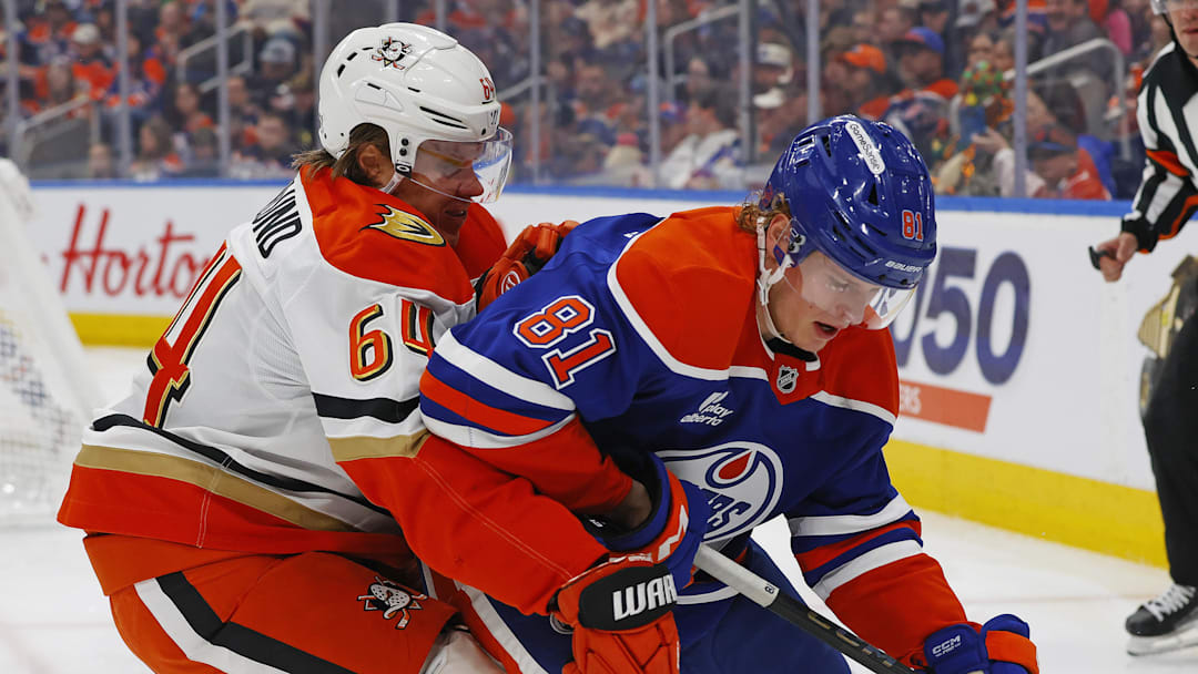 Mar 28, 2026; Edmonton, Alberta, CAN; Anaheim Ducks forward Mikael Granlund (64) and Edmonton Oilers forward Josh Samanski (81) battle along the boards for a loose puck during the second period at Rogers Place. Mandatory Credit: Perry Nelson-Imagn Images