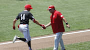 Jun 19, 2021; Omaha, Nebraska, USA;  NC State Wolfpack left fielder Jonny Butler (14) is congratulated by head coach Elliott Avent after hitting a home run against the Stanford Cardinal at TD Ameritrade Park. Mandatory Credit: Bruce Thorson-Imagn Images