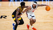 Mar 13, 2025; Indianapolis, IN, USA;  Illinois Fighting Illini guard Kylan Boswell (4) dribbles  the ball while Iowa Hawkeyes guard Josh Dix (4) defends in the first half at Gainbridge Fieldhouse. Mandatory Credit: Trevor Ruszkowski-Imagn Images