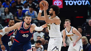 Apr 24, 2025; Inglewood, California, USA; Denver Nuggets guard Jamal Murray (27) controls the ball against Los Angeles Clippers center Ivica Zubac (40) during the second half of game three in the first round for the 2024 NBA Playoffs at Intuit Dome. Mandatory Credit: Gary A. Vasquez-Imagn Images
