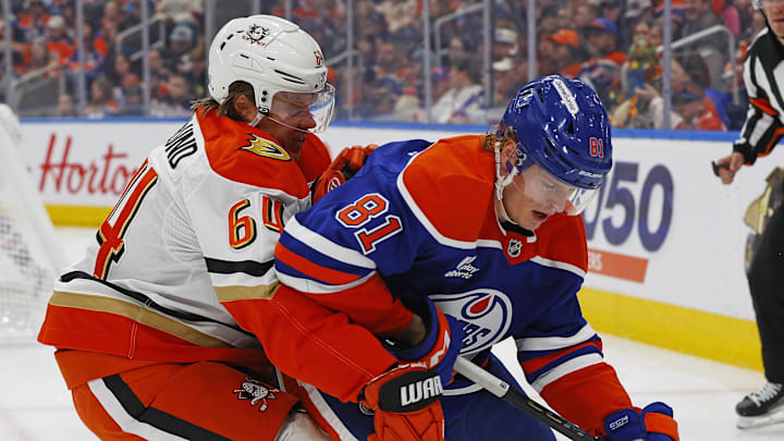 Mar 28, 2026; Edmonton, Alberta, CAN; Anaheim Ducks forward Mikael Granlund (64) and Edmonton Oilers forward Josh Samanski (81) battle along the boards for a loose puck during the second period at Rogers Place. Mandatory Credit: Perry Nelson-Imagn Images