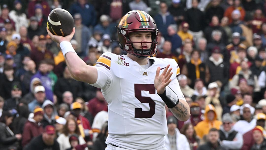 Nov 22, 2025; Chicago, Illinois, USA; Minnesota Golden Gophers quarterback Drake Lindsey (5) throws against the Northwestern Wildcats during the second half at Wrigley Field. Nov 22, 2025; Chicago, Illinois, USA; Minnesota Golden Gophers quarterback Drake Lindsey (5) throws against the Northwestern Wildcats during the second half at Wrigley Field.