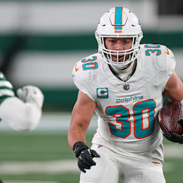 Miami Dolphins fullback Alec Ingold (30) runs with the ball during the second half as New York Jets cornerback D.J. Reed (4) pursues at MetLife Stadium. 