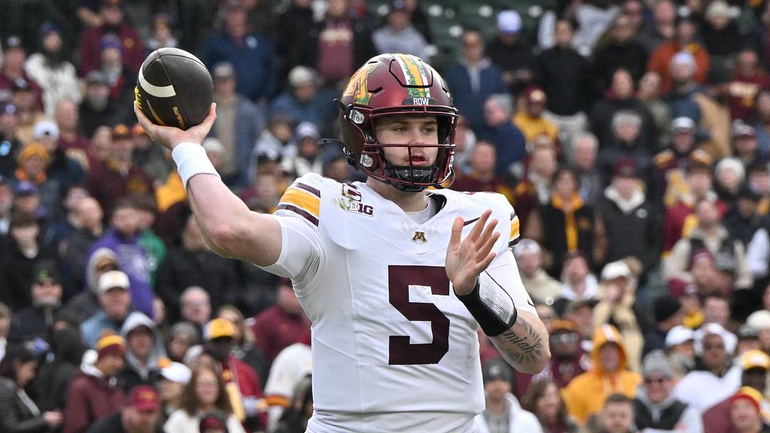 Nov 22, 2025; Chicago, Illinois, USA; Minnesota Golden Gophers quarterback Drake Lindsey (5) throws against the Northwestern Wildcats during the second half at Wrigley Field.