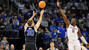 Mar 27, 2025; Newark, NJ, USA; Brigham Young Cougars guard Dallin Hall (30) shoots the ball against Alabama Crimson Tide center Clifford Omoruyi (11) during the first half during an East Regional semifinal of the 2025 NCAA tournament at Prudential Center. Mandatory Credit: Robert Deutsch-Imagn Images