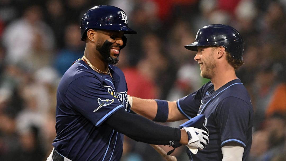 Boston, Massachusetts, USA; Tampa Bay Rays first baseman Yandy Diaz (2) celebrates with shortstop Taylor Walls (6) after scoring a run against the Boston Red Sox during the fourth inning at Fenway Park.