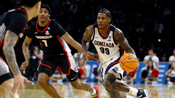 Mar 20, 2025; Wichita, KS, USA; Gonzaga Bulldogs guard Khalif Battle (99) dribbles against Georgia Bulldogs guard Tyrin Lawrence (7) in the second half of a first round men’s NCAA Tournament game at Intrust Bank Arena. Mandatory Credit: Nick Tre. Smith-Imagn Images