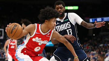 Jan 6, 2025; Memphis, Tennessee, USA; Memphis Grizzlies forward Jaylen Wells (0) drives to the basket as Dallas Mavericks forward Naji Marshall (13) defends during the third quarter at FedExForum. Mandatory Credit: Petre Thomas-Imagn Images
