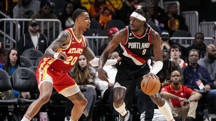 Mar 3, 2023; Atlanta, Georgia, USA; Portland Trail Blazers forward Jerami Grant (9) dribbles against Atlanta Hawks forward John Collins (20) during the second half at State Farm Arena. Mandatory Credit: Dale Zanine-USA TODAY Sports