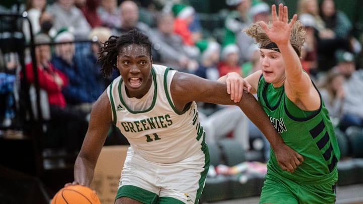 Christ School's Zymicah Wilkins moves toward the hoop as Caiden Brzozka guards, Dec. 12, 2023. Christ School's Zymicah Wilkins moves toward the hoop as Caiden Brzozka guards, Dec. 12, 2023.