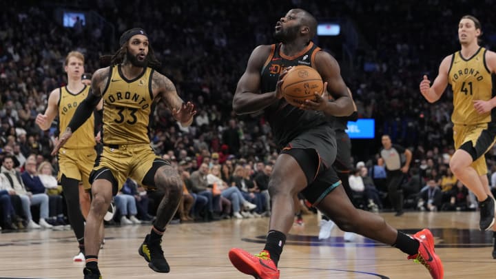 Apr 7, 2024; Toronto, Ontario, CAN; Washington Wizards forward Eugene Omoruyi (97) drives to the net as Toronto Raptors guard Gary Trent Jr. (33) closes in during the first half at Scotiabank Arena.