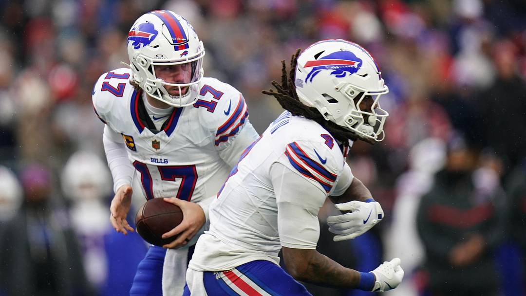 Dec 14, 2025; Foxborough, Massachusetts, USA; Buffalo Bills quarterback Josh Allen (17) fakes the hand off to running back James Cook III (4) against the New England Patriots in the second half at Gillette Stadium. 