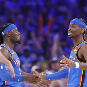 May 22, 2025; Oklahoma City, Oklahoma, USA; Oklahoma City Thunder guard Shai Gilgeous-Alexander (2) and Oklahoma City Thunder guard Luguentz Dort (5) celebrate after a play in the third quarter against the Minnesota Timberwolves during game two of the western conference finals for the 2025 NBA Playoffs at Paycom Center. Mandatory Credit: Alonzo Adams-Imagn Images