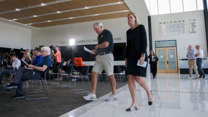 Iowa football Head Coach Kirk Ferentz, left, and Athletic Director Beth Goetz walk into a press conference Thursday, Aug. 22, 2024 in Iowa City, Iowa.