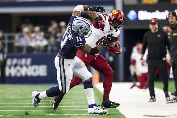 Dallas Cowboys linebacker Micah Parsons  tackles Washington Commanders running back Brian Robinson Jr. 
